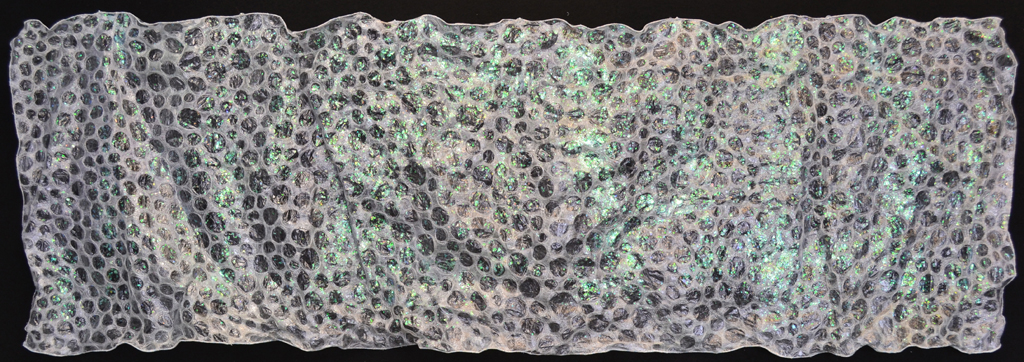 Aquatic Embrace. 23" h x 60" w x 2" d, Materials: plastic food film, non-woven polyester interfacing, recycled holographic wrapping paper, paint, threads