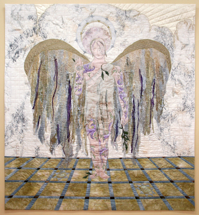 Gaerbhyth ~ Ambassador for Peace, 62" (h) x 56" (w), Quilted wall hanging, Hand dyed and hand painted cotton and other synthetics, textile and watercolour paints; Commercial fabrics; Various threads and cords; Angelina. Techniques: Machine piecing, Paper piecing and appliqué, Collage, Free Motion Embroidery, Bobbin stitching, Couching, Flour paste resist, Block printing and rubbing, Thermo-fabrication (heat applied), Hand dyeing and manipulated painting, Fusible web painting/bonding, Watercolour painting, Machine quilting.

Artist Statement:
Inspired by the calligraphies of The St. John's Bible and the sculptural wall of Coventry Cathedral's chapel, my faith and concern for world peace combine in this modern-day icon. Symbols of peace and community are incorporated throughout. Subtly placed as well as concealed from view, they suggest a global effort is essential. The Seraph has endured much, but hope remains; light penetrates and breaks down the wall. Peace will prevail. Hours and hours of work were dedicated to each separate part of this art quilt... Several different processes went into the creation of the background fabric alone. The androgynous body of the angel was projected onto the fabric, hand painted with the tribal tattoos, then stitched over in a filigree of thread. The arms had to be cut away, to place the collage that formed the wings underneath. Each step in Gaerbhyth's creation was an adventure!