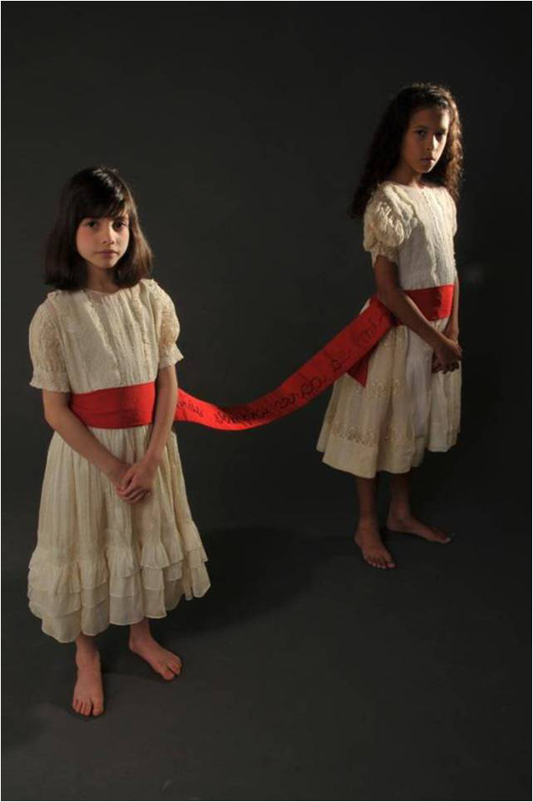 MEGELAS is based on a short film about the longing for the original unity, when differences and boundaries were absent from our garden. The umbilical belt represents the wholeness we search for in the other. It may manifest itself, for instance, in the soul mate, the imaginary best friend, or the lost twin.
Materials: Two found dresses; Japanese silk obi; ribbon. Hand sewn. 
Photo: Maurizio Donelli. Models: Amelia Wefer and Verónica Revelant.