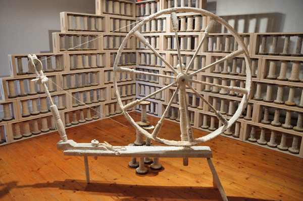 Spinning Jenny, salt and paper encrusted spinning wheel, 400 industrial bobbins filled with hand spun linen paper thread and encrusted with salt; hand built pine and hemlock shelves, 549 cm x 762 cm (room), 2013. Photo: Noelle Hamlyn