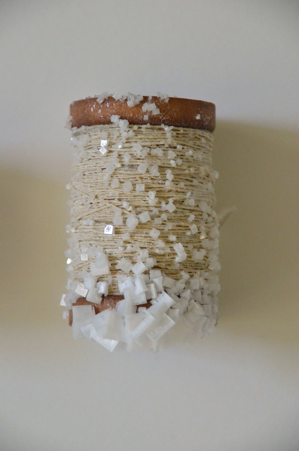 Spinning Jenny, salt and paper encrusted spinning wheel, 400 industrial bobbins filled with hand spun linen paper thread and encrusted with salt; hand built pine and hemlock shelves, 549 cm x 762 cm (room), 2013. Photo: Noelle Hamlyn