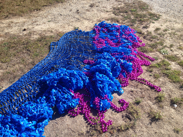 Swell, detail, (outdoor installation view at The Long Beach Island Foundation of the Arts and Sciences sculpture garden, Loveladies, New Jersey) 2013. Crocheted fluorescent flagging tape and metallic plastic beads, dimensions variable.