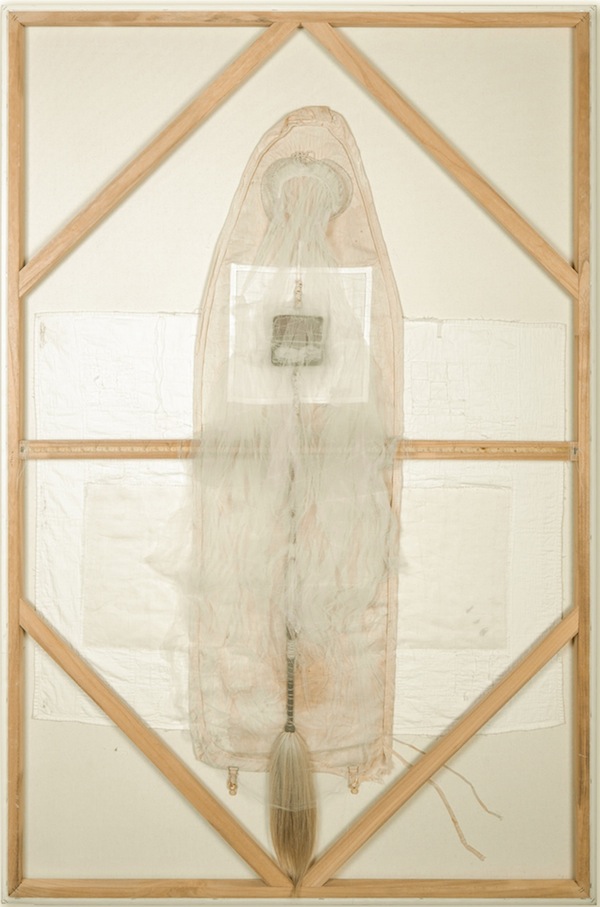 Cradle to Grave, Great Grandmother's baby quilt, Grandmother's ironing board cover, vintage veil, horsehair fly whisk, metal box, broken glass, thread on canvas – 2013, 60" x 48". Photo: Christian Carlson. Hours and lifetimes are contained in the quilts, the ironing boards, the wedding veils that are our legacy and our shroud. The layering of these common relics of the mother compress time and memory, asking the question of what remains.