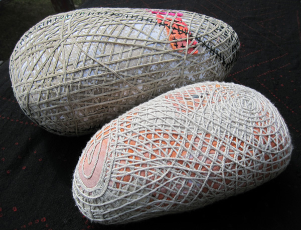 Two wrapped forms. Quilt batting, assorted fabrics and threads, suede or linen cord, lead weights. 10" x 17" x 5" 2008, 8" x 15" x 3" 2007. photo J Martin