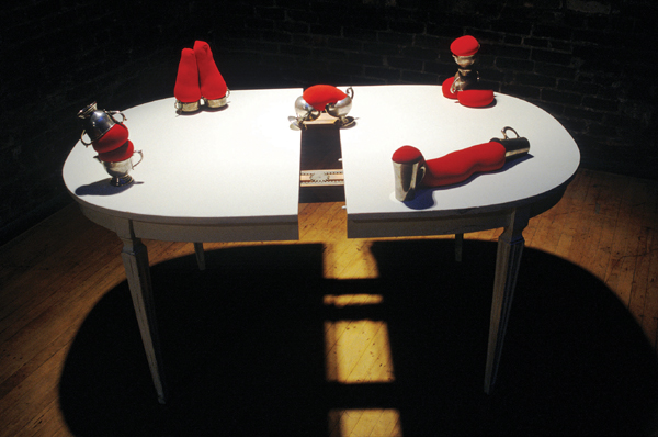 From the Home Project series, Couples 1998, wooden table, metal cups, tights, and sand.