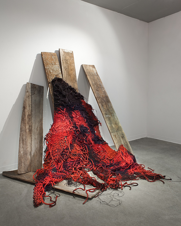 Cradling: In Ruins, 2014, 6 ½’H x 3’D x 4 ½’W, found barn wood, hand-dyed & burned sisal rope. Technique: Handmade large-scale weaving loom tapestry using plain & soumak weaves. When the weaving was completed, I burned the surface of the hand-dyed sisal ropes using a torch. Photo: Thomas Blanchard.

 