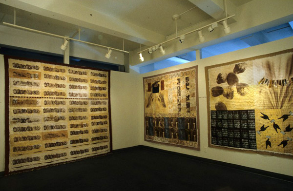 Installation, Cover Them, Arlette Montelmarcher 2/11/41,  91 x 91, Paulette Sommer 2/11/26, 75 x 76, Mathilde Dziubas 2/11/28, 67 x 74, Hand dyed fabric, drawn, rubbed with dye stick, van dyke print, hand applique, machine pieced, hand quilted, batting exposed. Photo: Mark Frey.