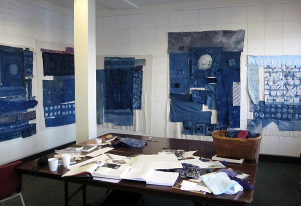 Studio View of work in progress with indigo fabrics dyed by the artist. A variety of stitch and paste resist methods are shown. The pin walls in Judy Martin's studio are made from 12" square ceiling tiles and are 9 feet high. Photo J Martin (2010)