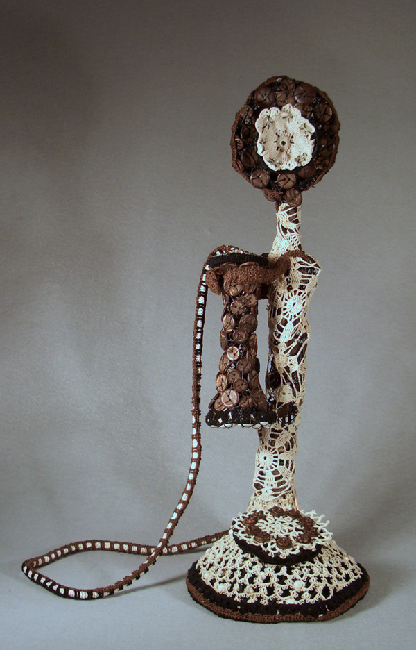 Charleston Queen, 2010, 21"H x 11"W x 8"D  (width variable by cord arrangement), Mixed Media Sculpture:  Antique and new cotton crochet with buttonwork over wire. Felt and fiberboard base.