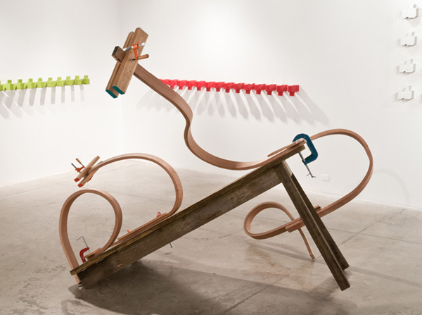What's Your Favorite Posish (No. 3)?, FAB Gallery, Virginia Commonwealth University, Richmond, VA. Hand-bent hardwood (red oak) on hand- constructed table, lumber, clamps, hardware, pastels, paint, 2011, 84" H x 90" W x 92" D, wood-bending and wood construction. Photo: David Stover.