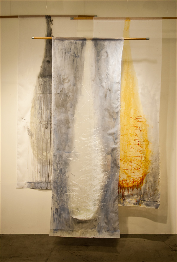 WifeMotherFacsimile; 2012; 84"x30" each; acrylic on polyester curtain shears, wood broom handles