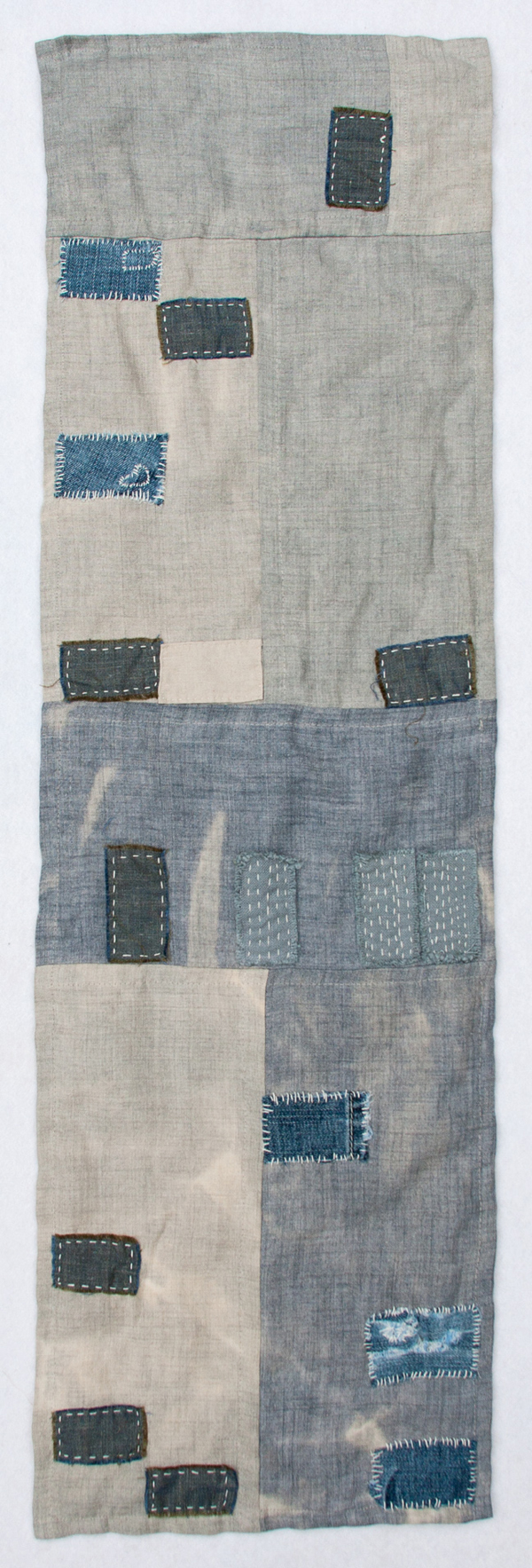 Las Vegas Foreclosure Quilt, 12"w x 36"h, Recycled denim, wool, yarn and embroidery thread on bleached linen, Hand sewn quilt, Photo: Kathryn Clark