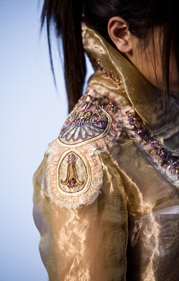 Hand & Lock Competition in U.K.  – Epaulette detail-Jacket is constructed of silk organza, with embroidered’ patches’ constructed of tea stained gauze, overlaid with crystal organza.  All layers are machine stitched and then hand embroidered and beaded.  Photographer-John Heineman