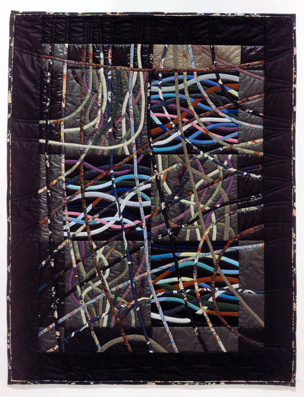 Tangled Web, 1988, quilt, 56" x 72", machine pieced and quilted cottons and polyester, Shown at Quilt Evolutions, Museum for Textiles, January 1990 This work explores the possibilities of linear course using bias cut fabric. The bias cut lines bend and curve in a very free manner. Shown at Quilt Evolutions, Museum for Textiles, January 1990 Collection of Eugene and Cathleen Beck, Toronto.