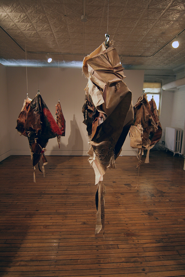 Meat Market, (Taller Boricua, NYC) Acrylic & Oil on Canvas, Raw Canvas, Cloth and Meat Hooks, 2011, dimensions variable, hand knotted installation. Photo: Courtesy of the artist.