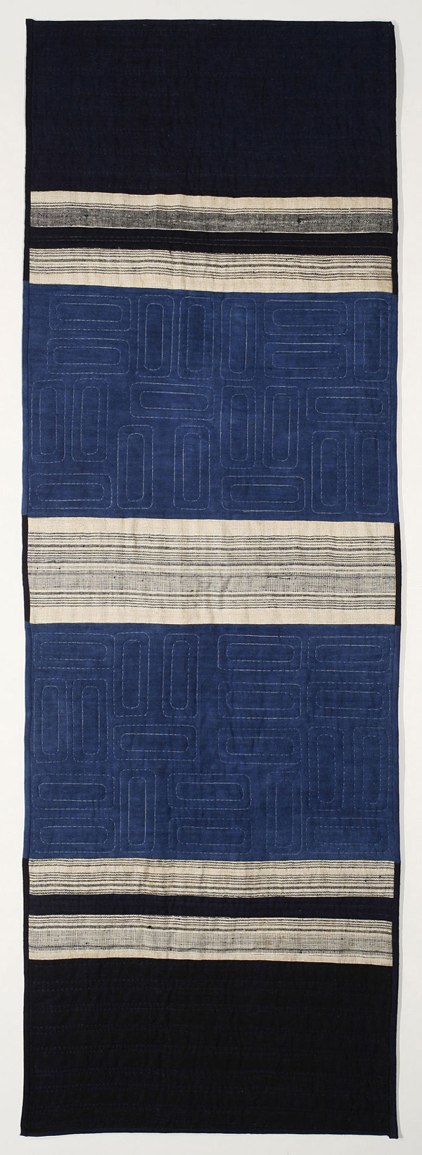 Vietnam, 23.5in. x 70in., indigo hand-dyed cotton from Vietnam farms and villages, hand quilted by the Martin sisters.