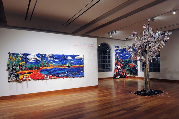 MacLaren Installation Dec 2008 left to right, Grand Lake,  recycled hockey gear and oil paint on plywood, 48" x 144", 2007.
 
Maple LEAF Tree, recycled hockey sticks and hockey cards on wooden armature, height is 14 feet tall, 2008. Bayside Field: A View to St. Croix Island, recycled hockey gear and oil paint on plywood, 120" x 60" x 60", 2008