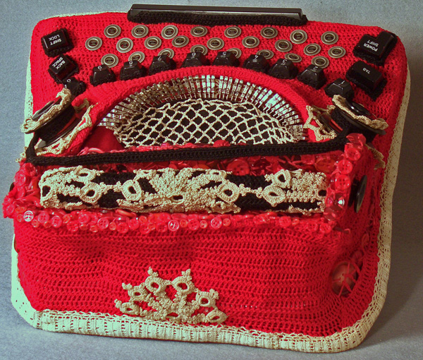 The Happiest Christmas Typewriter, 2011, 6"H x 13.5"W x 12"D, Mixed Media Sculpture:  Cotton crochet, button work, embroidery and linen threads, antique doilies and trim, old typewriter parts, wool knit and fabric lining and platform. Armature of wire, needlepoint canvas, clay and wood.