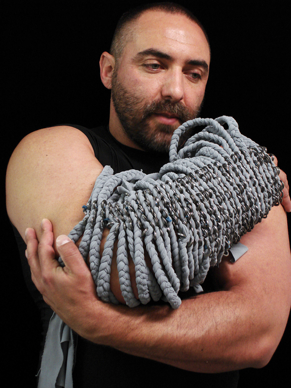 Arms #7, 2007. Braided spandex and washers modeled by Andrew Criss, approx. 16" x 8" x 8".