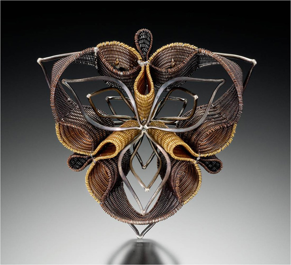Recursive Brooch, 2009. Copper, brass, sterling silver and nylon monofilament. Double-cloth on 4 harness floor loom. Hand forged and fabricated jewelry components. 3" x 3" x 1"