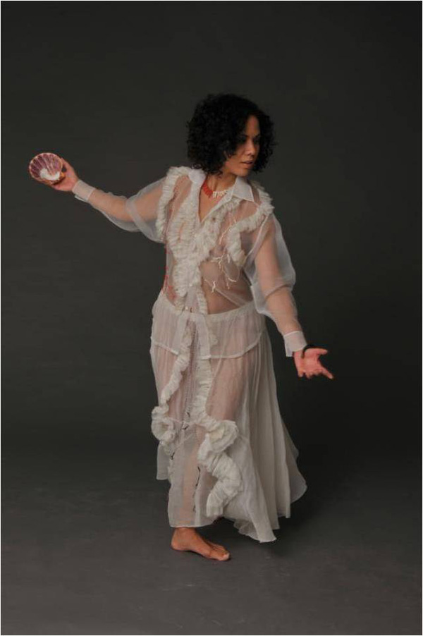 NIEVES EN CHIPRE is about Snow White (white, red and black) who turns into Aphrodite (shining sea spray). The princess has some unfinished business with her mother, and maternity, to solve before she might be ready to awaken from her dream into the alchemical process of spinning straw into gold.
Materials: Appropriation of an organza shirt by designer Carlos Arturo Loreto; organza family undergarment; coral; glass beads; nylon and cotton thread. Hand sewn.
Photo: Maurizio Donelli. Model: Adriana Rondón.