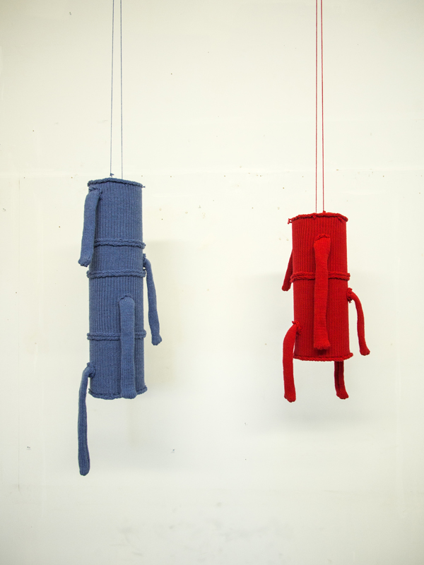 Two Solitudes, I Destroy What I love, Blue, 38 inches high,8 diameter. Red, 26 high, 8 diameter, Knitted synthetic yarn, sono tubes, 2012. Photo: Andrew MacDonald.