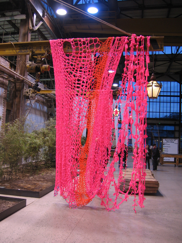 Ribbons and Bows, (installation view at Urban Outfitters Headquarters, Philadelphia, Pennsylvania) 2011. Crocheted and knotted Glo-Pink fluorescent flagging tape and children's barrettes, dimensions variable.