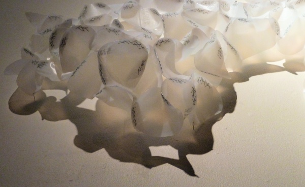 Lucid (detail), plastic milk bottles, staples, shadow & light, installation: Port Angeles Fine Art Center, WA, photo: Barbara De Pirro