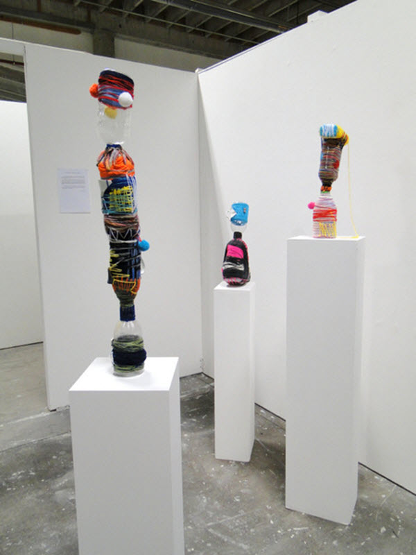 Bottle Sculptures, plastics, ceramics, wool, thread, glue, 2013, dimensions variable, exhibition installation view. Photo: Louise Keen.