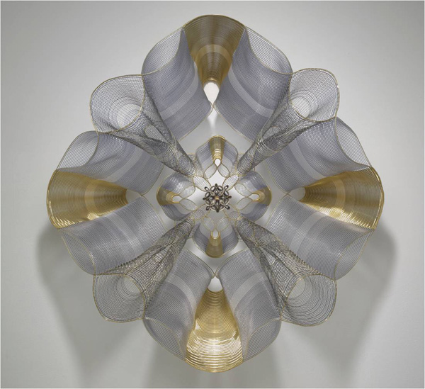 Landau for the Maharaja, 2009. Brass, plastic filaments, fine silver, sterling silver, copper, brass, nylon monofilament and citrine. Double-cloth on 4 harness floor loom. Acid dyed nylon. Hand forged and fabricated jewelry components. 36" x 36" x 15".

The elegance of geometry is expressed through graceful, undulating forms of metal and monofilament, inspired by mandalas.