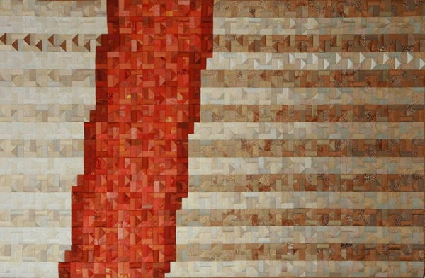 Impressies (Impressions) (140 x 84 cm), Materials: silks, cottons

Basis for the design is an aerial photograph of an avenue in Dachau. The pattern of small triangles and rectangles was derived from the Korak technique. In order to interrupt the pattern I repeatedly left a row of white triangles, so they clearly stand out and ultimately to the top row I did the same with a brown triangle in the opposite direction (contrast, direction and color). The quilt was shown during an international exhibition of the Irish Quilters Guild in July and August 2005 at Dublin.