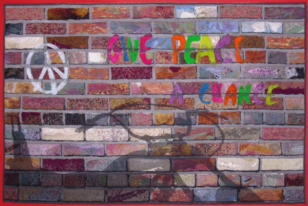 Remembering 1969, soft framed, 60" x 40", stitched and felted scraps, painted organzas, black tulle, machine stitched.