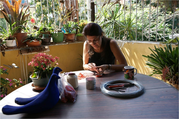 Working on the HANDLESS BRIDE’s bracelets. I don’t use a specific area for a studio: my whole home is a working space. You may find me sewing on the couch, on the terrace, in the kitchen or on top of my laptop. Photo: Juan Lecuna.