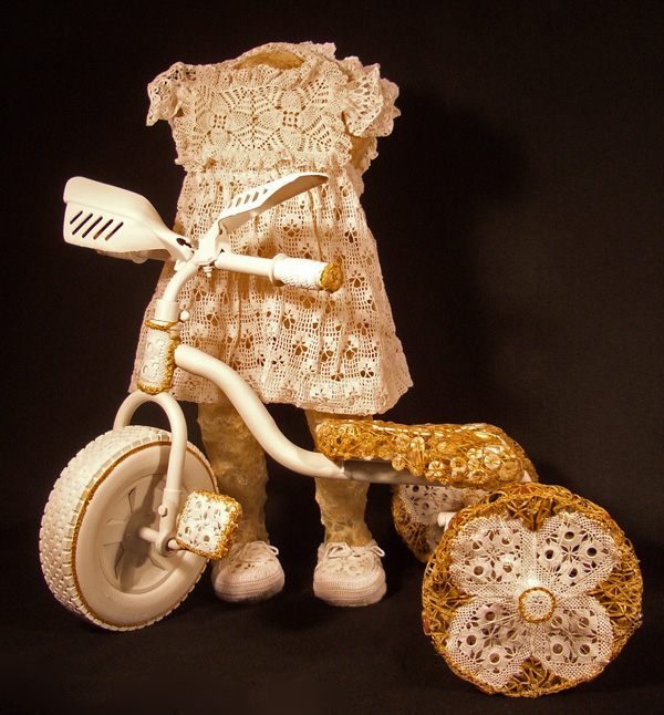 Triker, 2009  (2 objects = 1 artwork), Triker Girl:  32"H x 14"W x 13"D, Tricycle:  24"H x 26"W x 21"D, Mixed Media Sculpture:  Cotton, linen and artificial sinew threads; buttons; wire; gut; recycled parts of metal tricycle; and reconstructed antique doilies.  Crochet, button work and gut application over aviary wire armature.