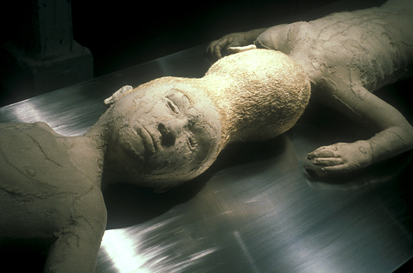 Confessional, size variable,1996, Duratrans, light box, hand sewn figure, christening gown, photo mural, figure sewn from wedding dress, human hair, sound. Original installation with Nether Mind Artists' Collective, Toronto. Photo: Simon Glass. Collection of the Kamloops art Gallery.