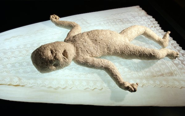 Confessional, size variable, 1996, Duratrans, light box, hand sewn figure, christening gown, photo mural, figure sewn from wedding dress, human hair, sound. Original installation with Nether Mind Artists' Collective, Toronto. Photo: Simon Glass. Collection of the Kamloops art Gallery.