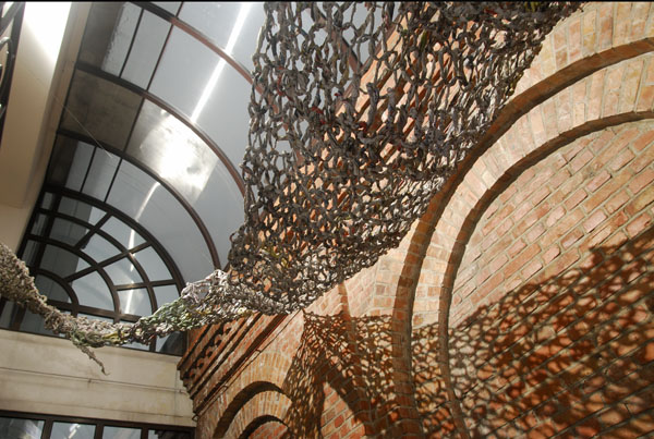 Magic Carpet Ride, 80'x12'x15', newspaper, spinning technique and knitting technique, Lodz, Poland, 2011.