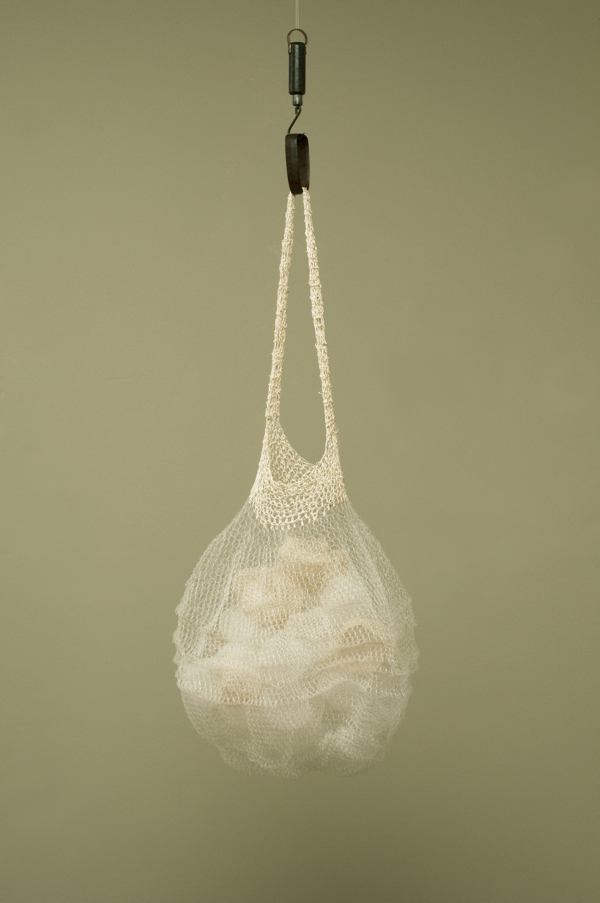 Full (Basket), 2011, 66" x 12.5" x 16.25", Monofilament, thread, iron, silk. 
Technique crochet. Photo: John Carlano.