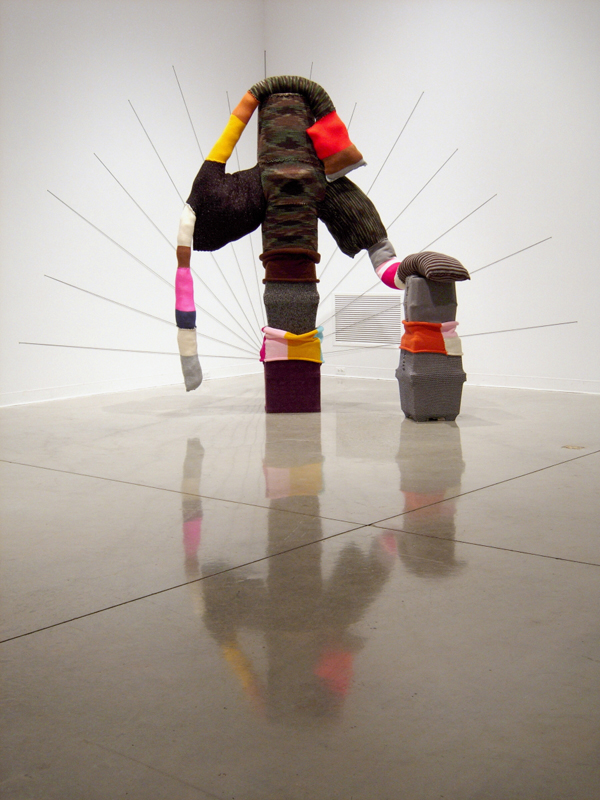 Slouch Beast, Knitted synthetic yarn, pillow stuffing, various plastic forms, nails, Variable dimensions, 2008. Photo: Andrew MacDonald