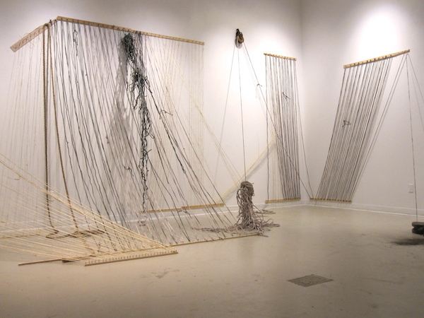 Enveloped, 2013, 10’H x 6’D x 43’W, Sisal, hand-dyed cotton rope, wood, nails, found pulleys. Technique: Handmade, hand-dyed large-scale weaving loom using only a warp. Photo: Mary Grisey. 