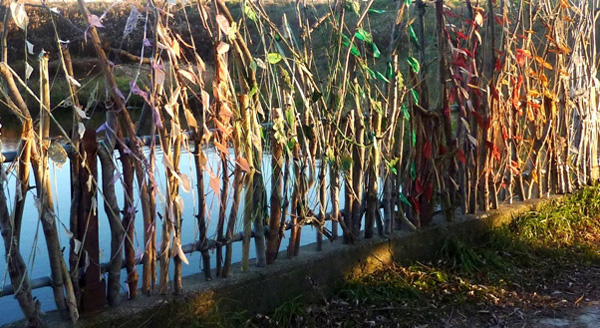 Passage, 20'w x 12'h, this is an outdoor sculpture located on the grounds of the Joshua Creek Art Centre in Oakville, Ontario. It depicts the passage of life, with over 500 hand-made fibre leaves, cording, fabric, thread and wood (tree branches). Photo credit: Bob Steele