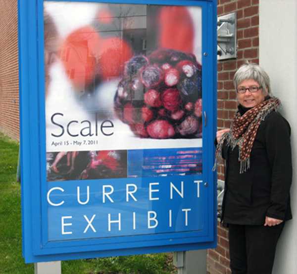 Artist – Outside by sign of opening exhibit 'SCALE' at the Attleboro Arts Museum, Attleboro MA; April 2011