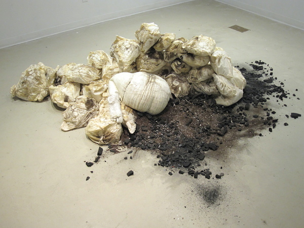 Of Synchronicity, 2013, 9’H x 2’D x 5’W, plaster, wax, muslin, rubber latex, sisal, hand-dyed cotton rope, wood, pulley, dirt. Technique: Handmade, hand-dyed large-scale weaving loom using only a warp, plaster-cast hands, hand-sewn muslin. Photo: Mary Grisey. 