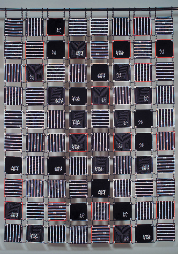 Unchained?, back. Quilt Commercial fabrics, metal chain, grommets, machine appliquéd and quilted, 2006 73" x 56", Photo: Tom Fitzpatrick