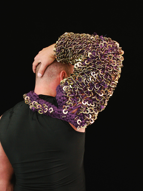 Arms #7, 2007. Braided spandex and washers modeled by Andrew Criss, approx. 16" x 8" x 8".