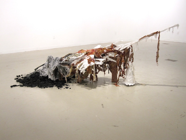 Lest She is Forgotten, 2012, 2’H x 6’W, plaster, chicken wire, upholstery fabric, foam, wood, charcoal, house paint, sisal. Technique: Wood, plaster & chicken wire armature with ripped layers of upholstery fabric. Photo: Mary Grisey. 