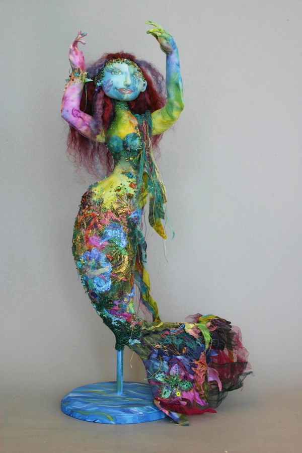 Wave Dancer, 18" H, cotton cloth, ribbon, beads, ribbon, wooden stand.