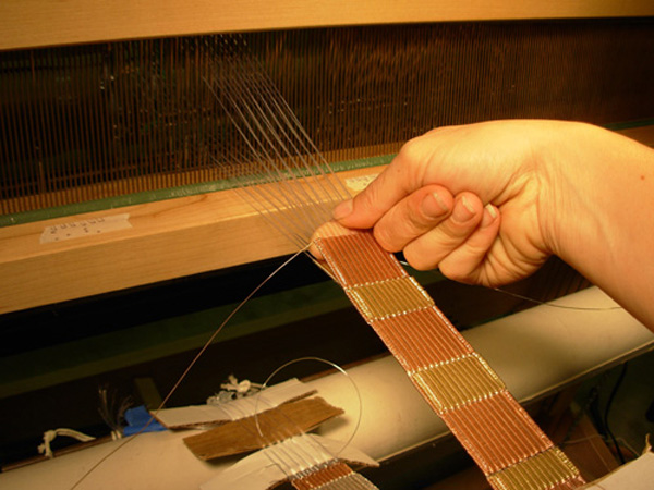 In process: detail of woven double-cloth, nylon monofilament warp and copper/brass weft