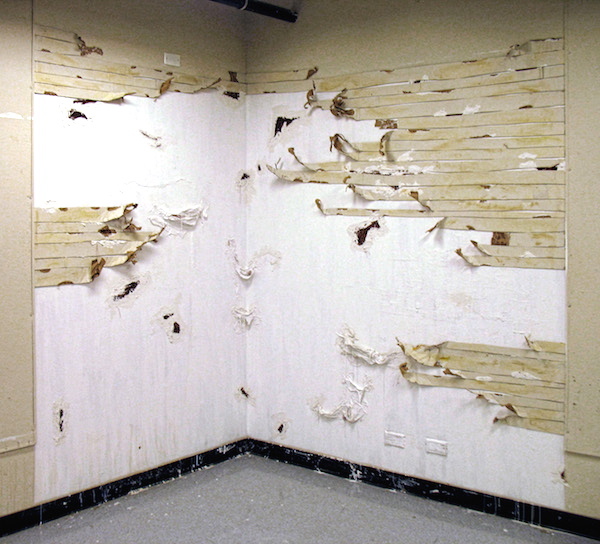Silence is White, 2008, 8’H x 6’W, cardboard, plaster, cheesecloth, upholstery fabric, ink, coffee, paint. Technique: Layering materials on top of the gallery wall, then dismantling them. Photo: Mary Grisey. 