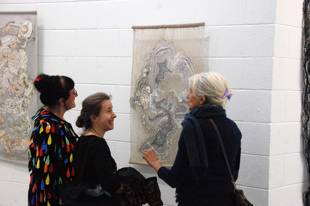 Ragnhild Monsen and Szilvia Revesz at the Festival Opening, discussing their artwork with a visitor.